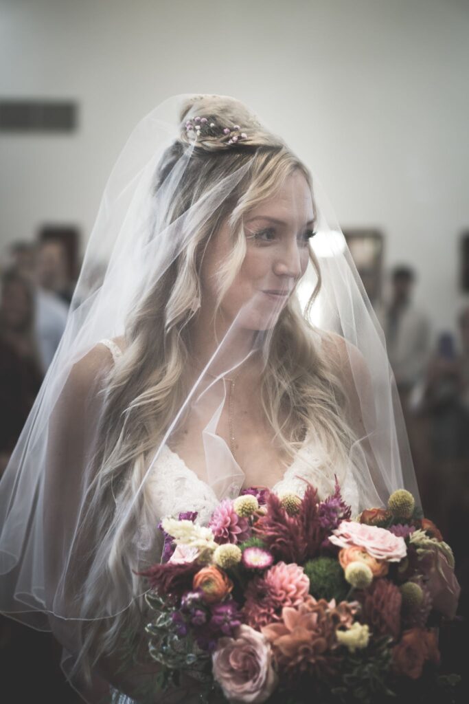 Bride walking down the aisle with flowers